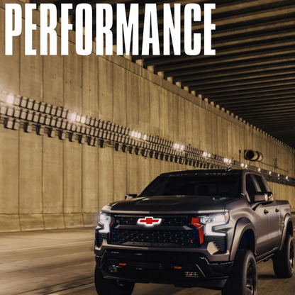 Silverado with illuminated red/black Bowtie emblem in tunnel — rolling shot