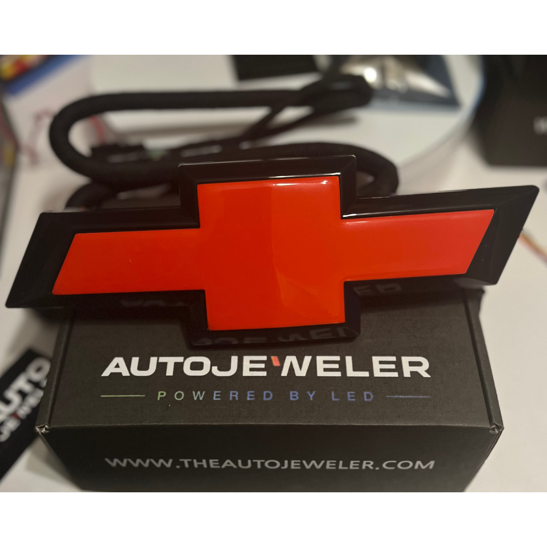 AutoJeweler red/black LED Bowtie emblem with plug-and-play harness on branded box