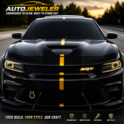 AutoJeweler SRT LED grille emblem glowing yellow on a black performance Charger with matching yellow accent stripes and custom automotive lighting.