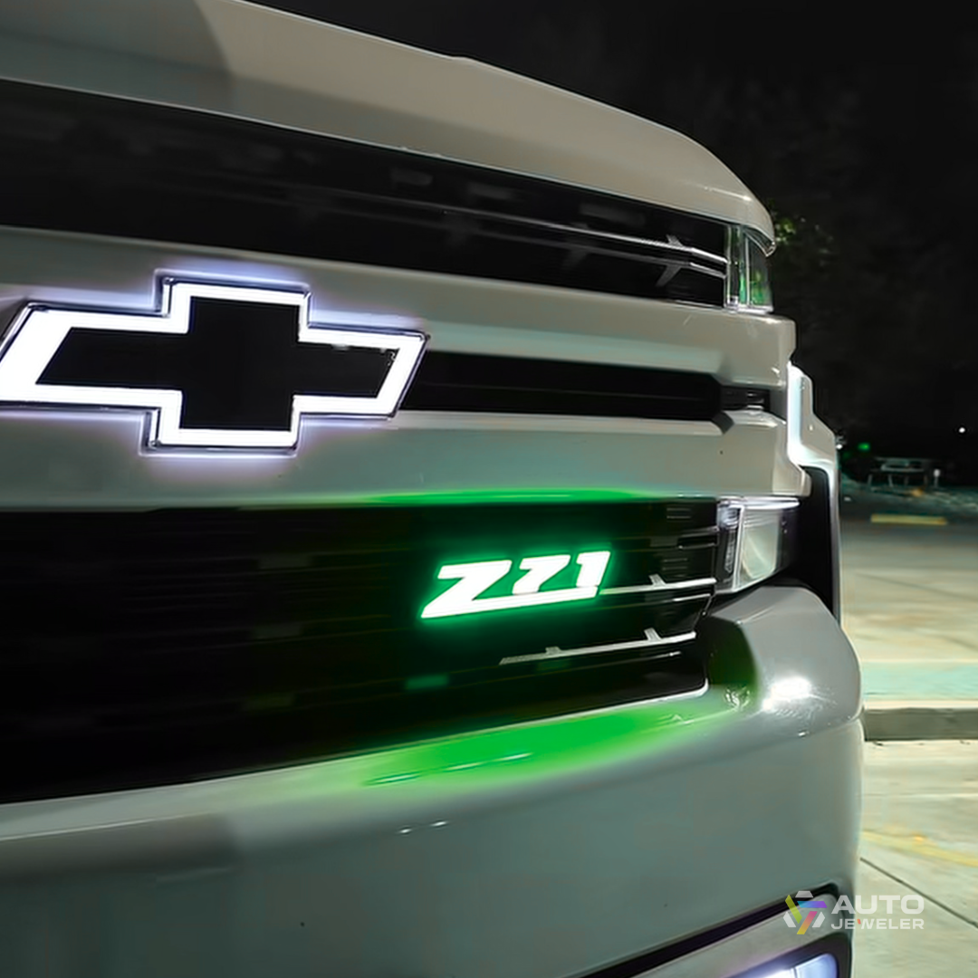 Z71 LED grille emblem glowing green installed on Chevy truck showing bright RGB color option with underglow reflection