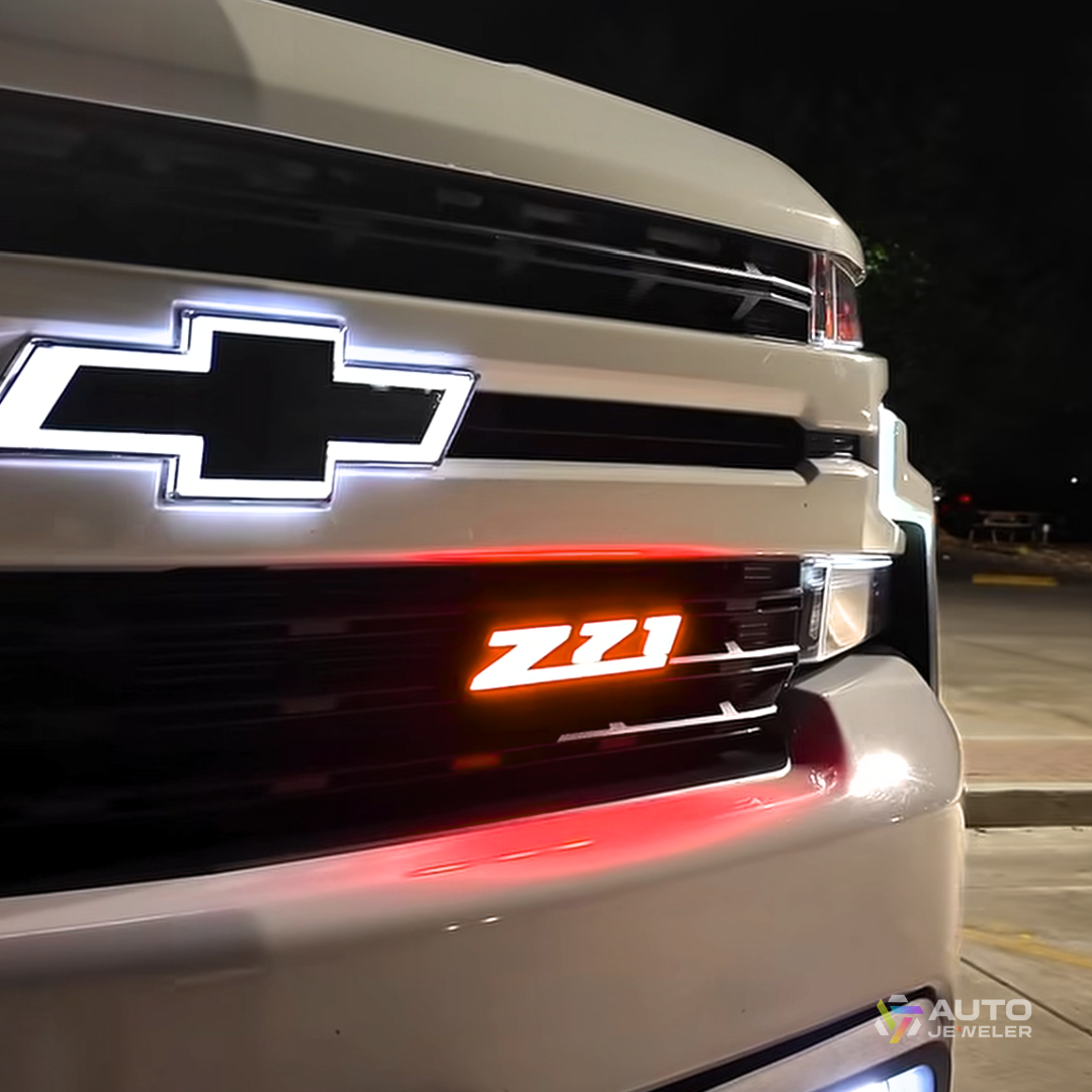 AutoJeweler Z71 LED grille emblem glowing red installed on Chevy truck for aggressive nighttime appearance
