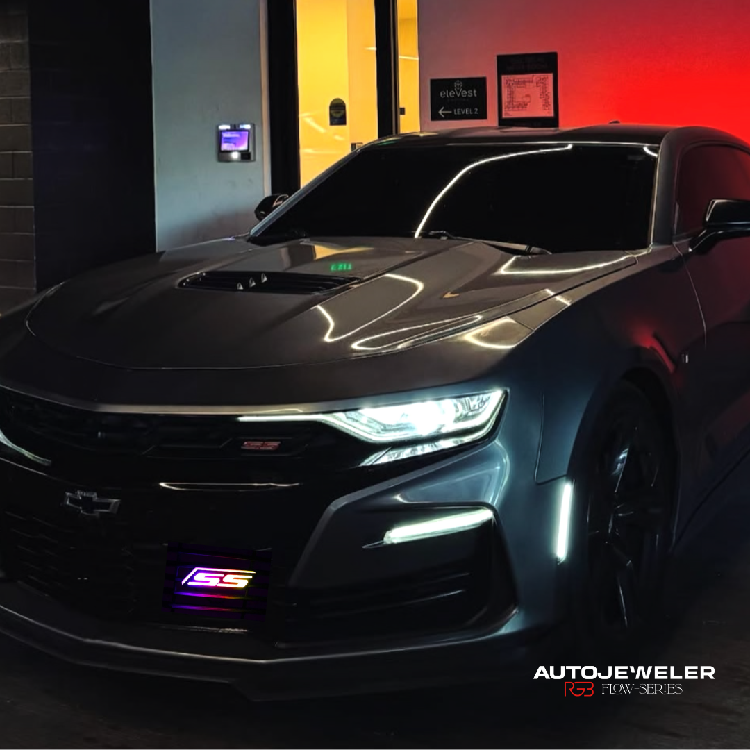Chevy Camaro SS with RGB Flow Series LED grille emblem installed, shown at night with multicolor lighting on front grille