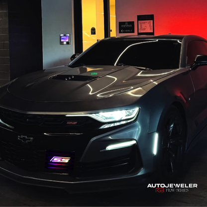 Chevy Camaro SS with RGB Flow Series LED grille emblem installed, shown at night with multicolor lighting on front grille
