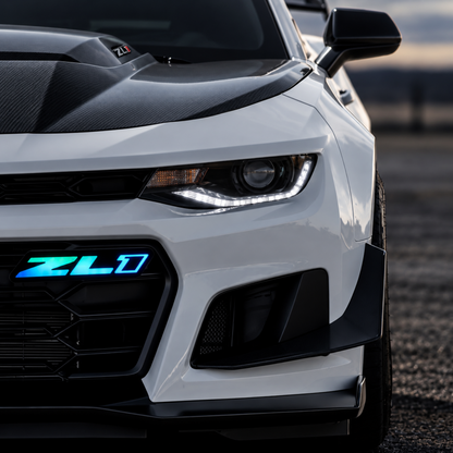 Close-up of Camaro ZL1 Gen 2 Flow Series LED grille emblem illuminated blue and cyan