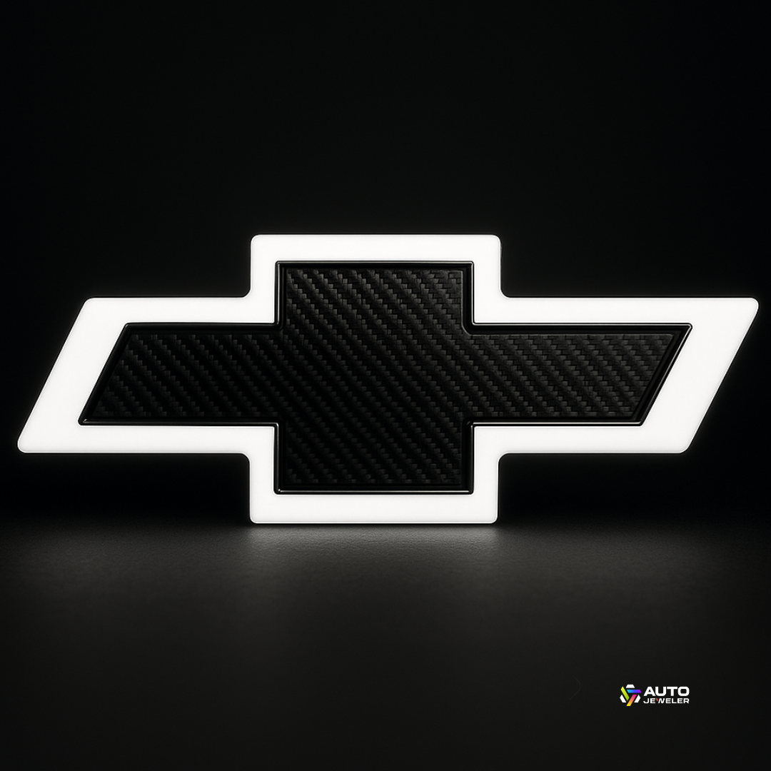 White-glow Chevy bowtie with carbon center on black studio background—AutoJeweler lighted grille emblem.
