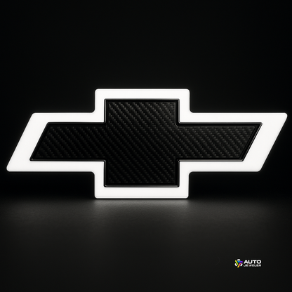 White-glow Chevy bowtie with carbon center on black studio background—AutoJeweler lighted grille emblem.