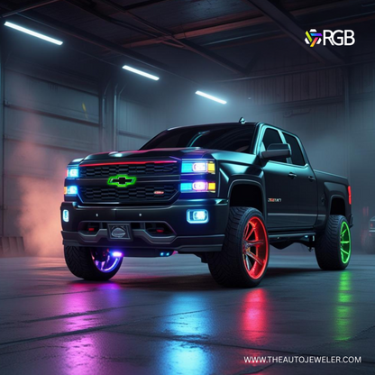 Black Chevy Silverado with RGB LED bowtie grille emblem, vibrant green glow, and AutoJeweler branding in a garage – theautojeweler.com