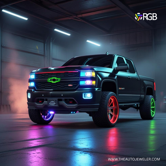 Black Chevy Silverado with RGB LED bowtie grille emblem, vibrant green glow, and AutoJeweler branding in a garage – theautojeweler.com