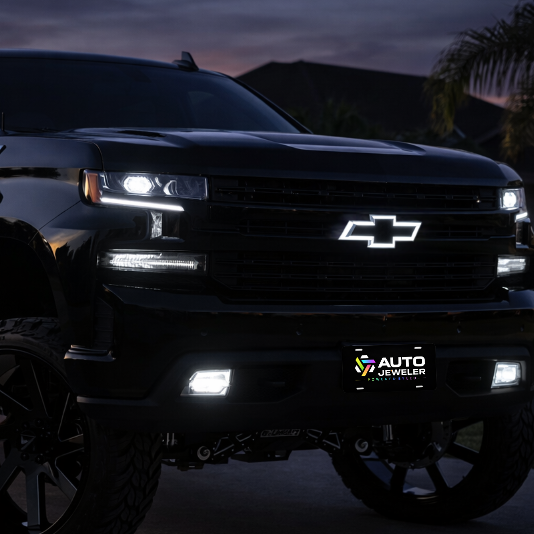 2014–2015 Chevy Silverado 1500 with black chrome RGB LED bowtie grille emblem glowing, with AutoJeweler branded License plate