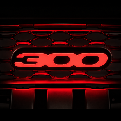 Chrysler 300 illuminated grille emblem glowing bright red with premium LED lighting, gloss black housing, and aggressive custom grille installation appearance.