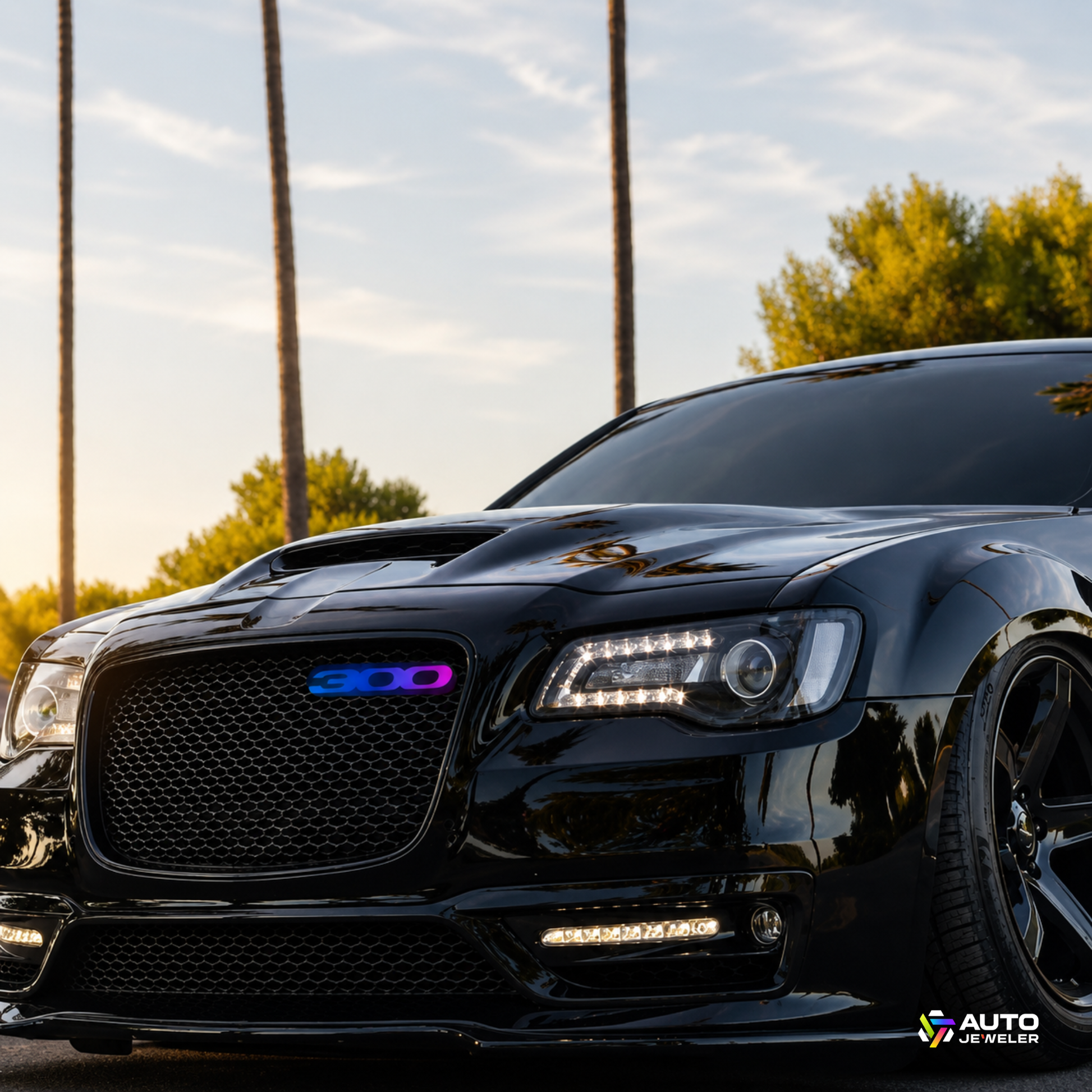 RGB Flow Series Chrysler 300 LED grille emblem installed on a black Chrysler 300 featuring animated multicolor lighting and custom luxury vehicle styling.
