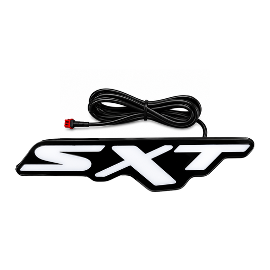 Dodge SXT LED grille emblem with black housing, white face and attached power cable on a white background.
