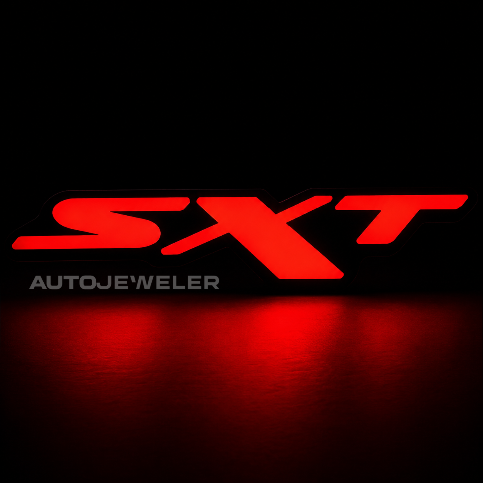 Dodge SXT RGB Flow Series LED grille emblem illuminated solid red on a black background