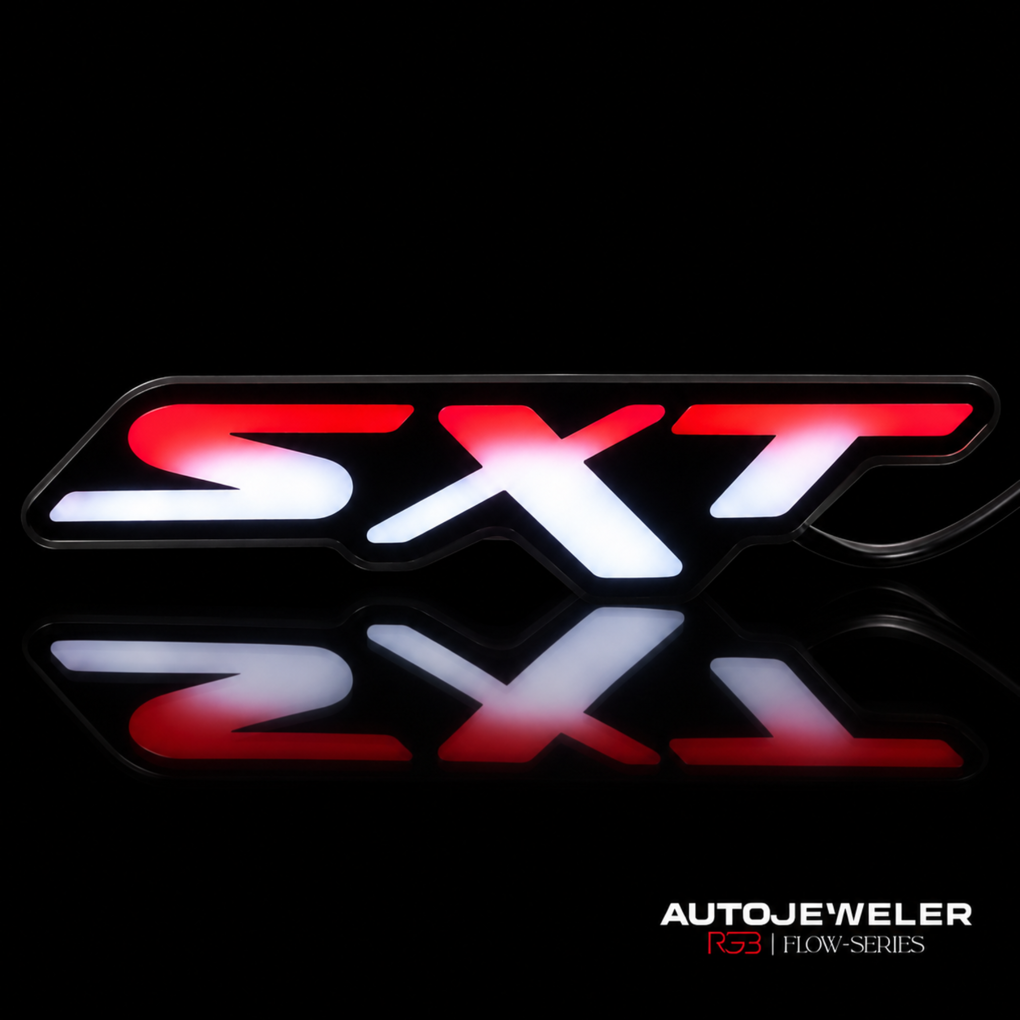 Dodge SXT RGB Flow Series LED grille emblem illuminated in red and white with reflection on a black surface.