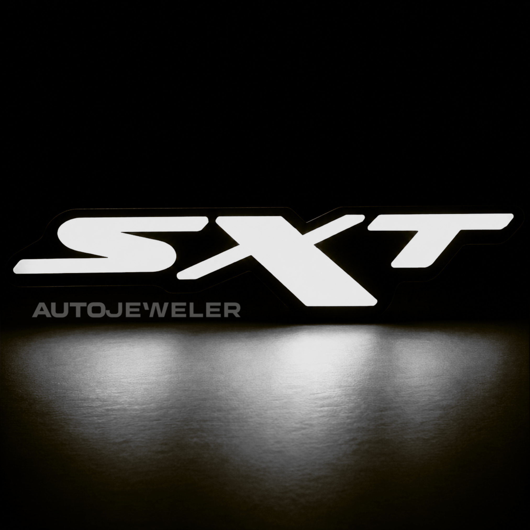 Dodge SXT RGB Flow Series LED grille emblem illuminated solid white on a black background.