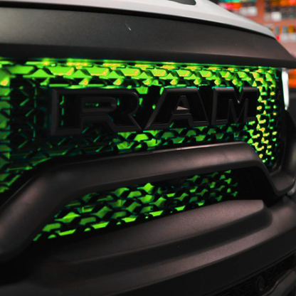 Close-up of Flow Series RGB grille lighting installed behind grille mesh with vivid green illumination