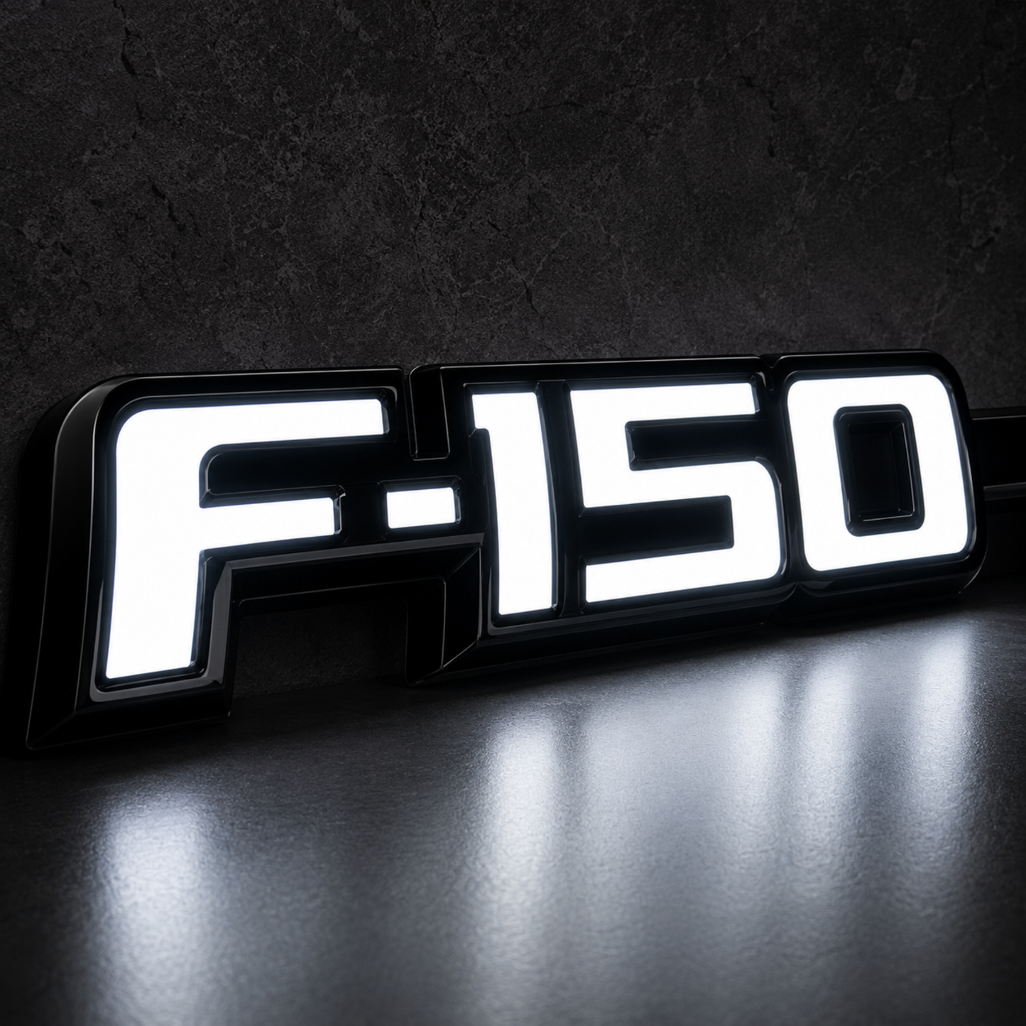 Close-up of Ford F-150 LED Fender Emblem for 2009-2014 trucks showing bright white illumination with black housing and chrome OEM style lettering.