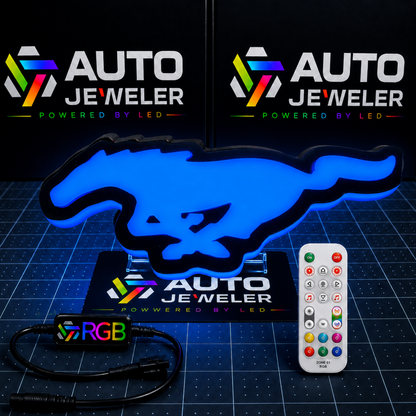 Ford Mustang Pony RGB LED grille emblem illuminated blue with RGB controller, wiring harness, and handheld remote.