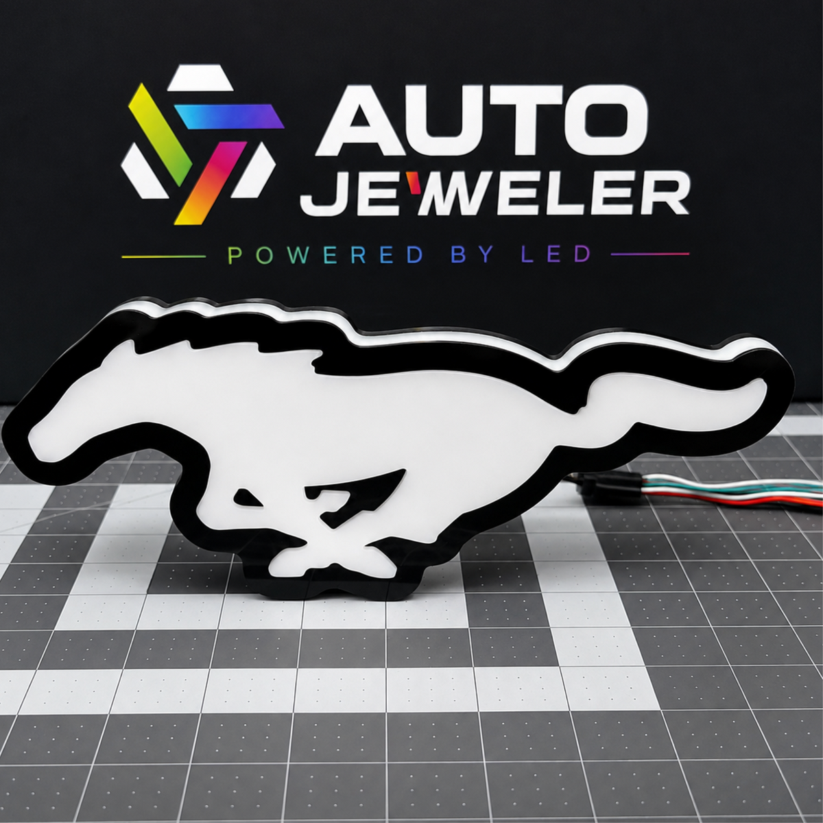 Ford Mustang Pony RGB LED grille emblem shown from the front unlit with black trim and white diffuser face.