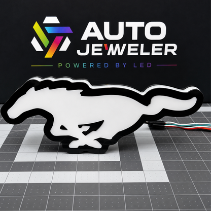 Ford Mustang Pony RGB LED grille emblem shown from the front unlit with black trim and white diffuser face.