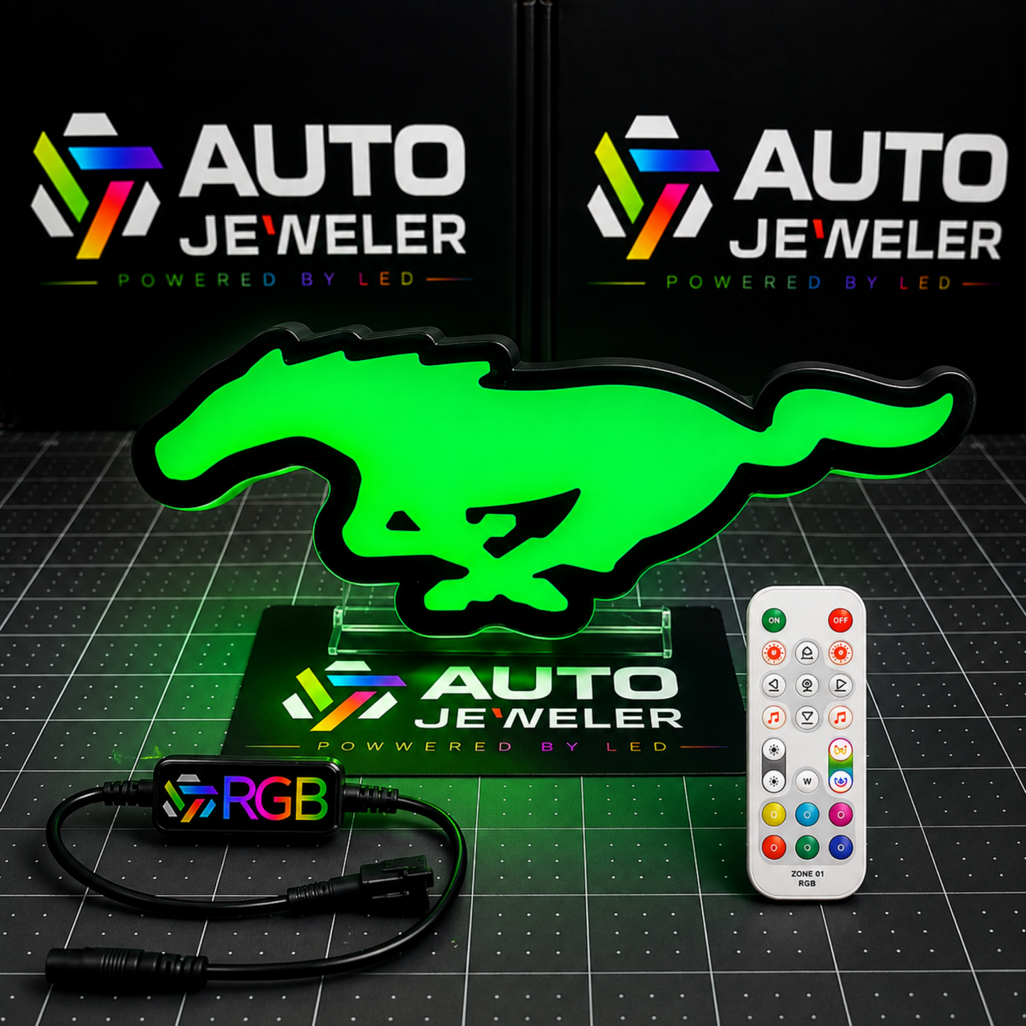 Ford Mustang Pony RGB LED grille emblem illuminated green with RGB controller, wiring harness, and handheld remote.
