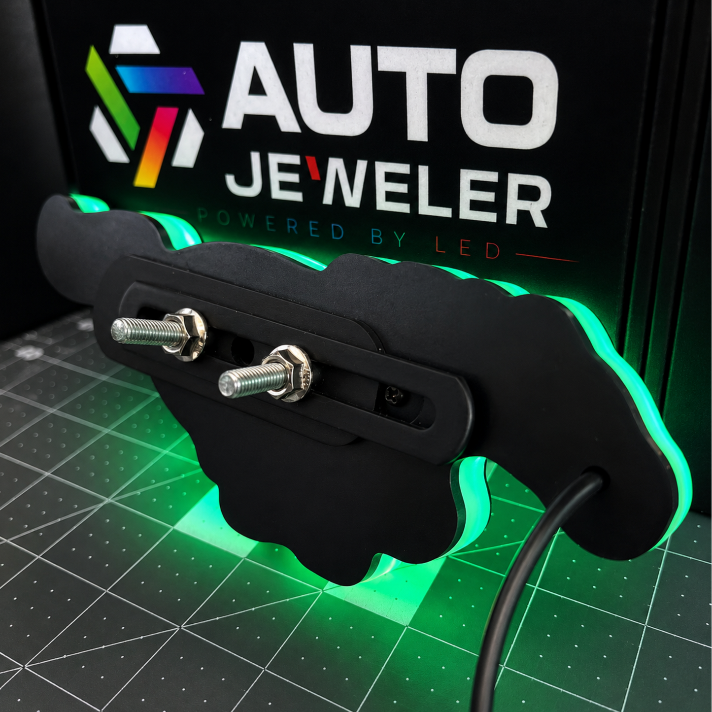  Rear view of Ford Mustang Pony RGB LED grille emblem showing mounting studs, nuts, wiring, and illuminated edge.