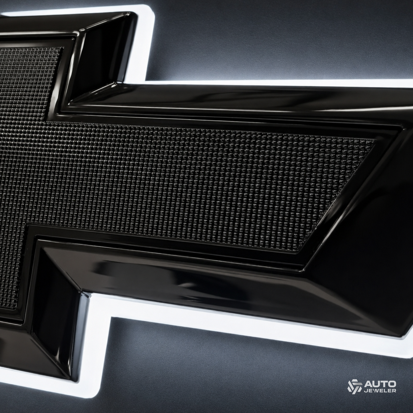 Close-up of the bowtie's textured black center, gloss black border, and pure white halo lighting.