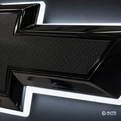 Close-up of the bowtie's textured black center, gloss black border, and pure white halo lighting.