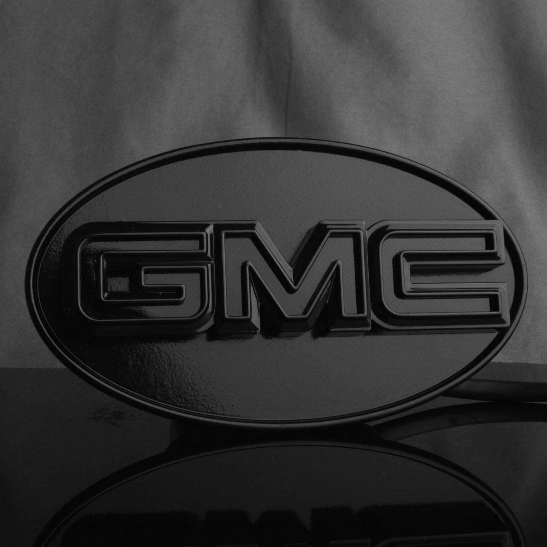 Front view of gloss black GMC LED hitch cover showing raised GMC lettering and smooth black finish