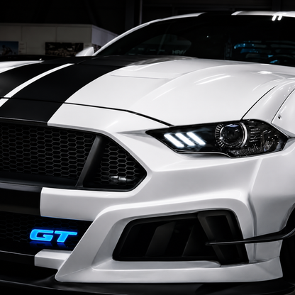 Lifestyle photo of customized 2025 Ford Mustang GT at night with an AutoJeweler Premium LED Illuminated GT grille logo glowing bright blue.