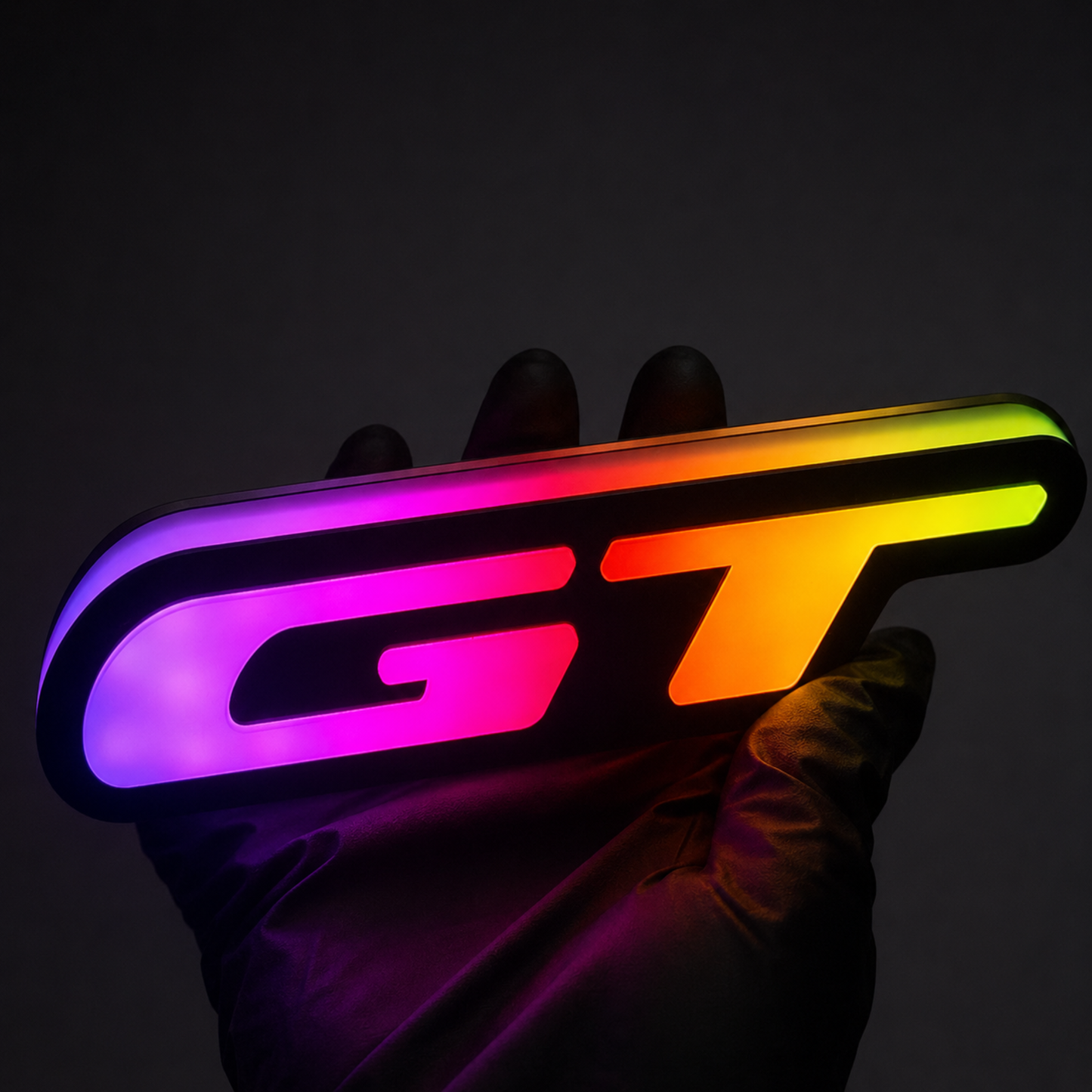 GT Flow Series RGB LED grille badge with dynamic color-chasing illumination, featuring vibrant multicolor lighting effects and premium custom styling for Ford Mustang GT vehicles.
