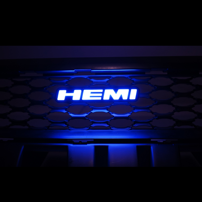 HEMI LED emblem glowing blue installed on vehicle grille showing bright illuminated badge at night