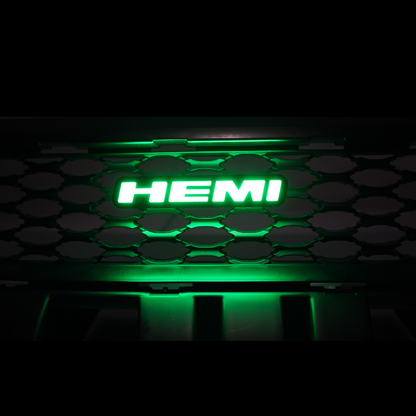 HEMI LED emblem glowing green installed on vehicle grille showing bright illuminated badge at night