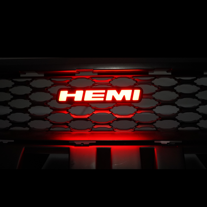 HEMI LED emblem glowing red installed on vehicle grille showing bright illuminated badge at night