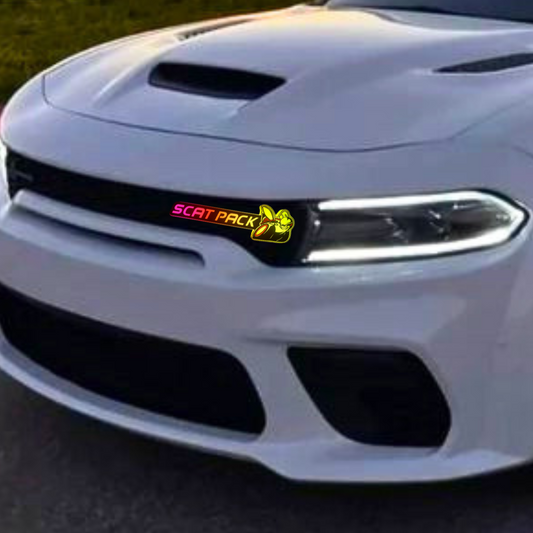 White dodge charger with  RGB Flow-Series Scat Pack' logo installed and glowing pink, red, yellow
