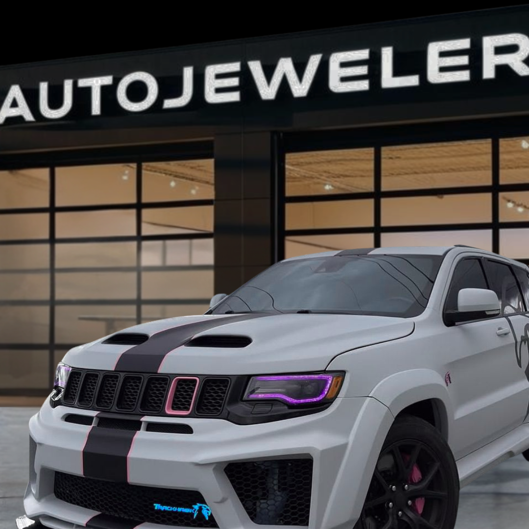Jeep Trackhawk RGB Flow Series LED grille emblem installed on front bumper shown in front of AutoJeweler storefront