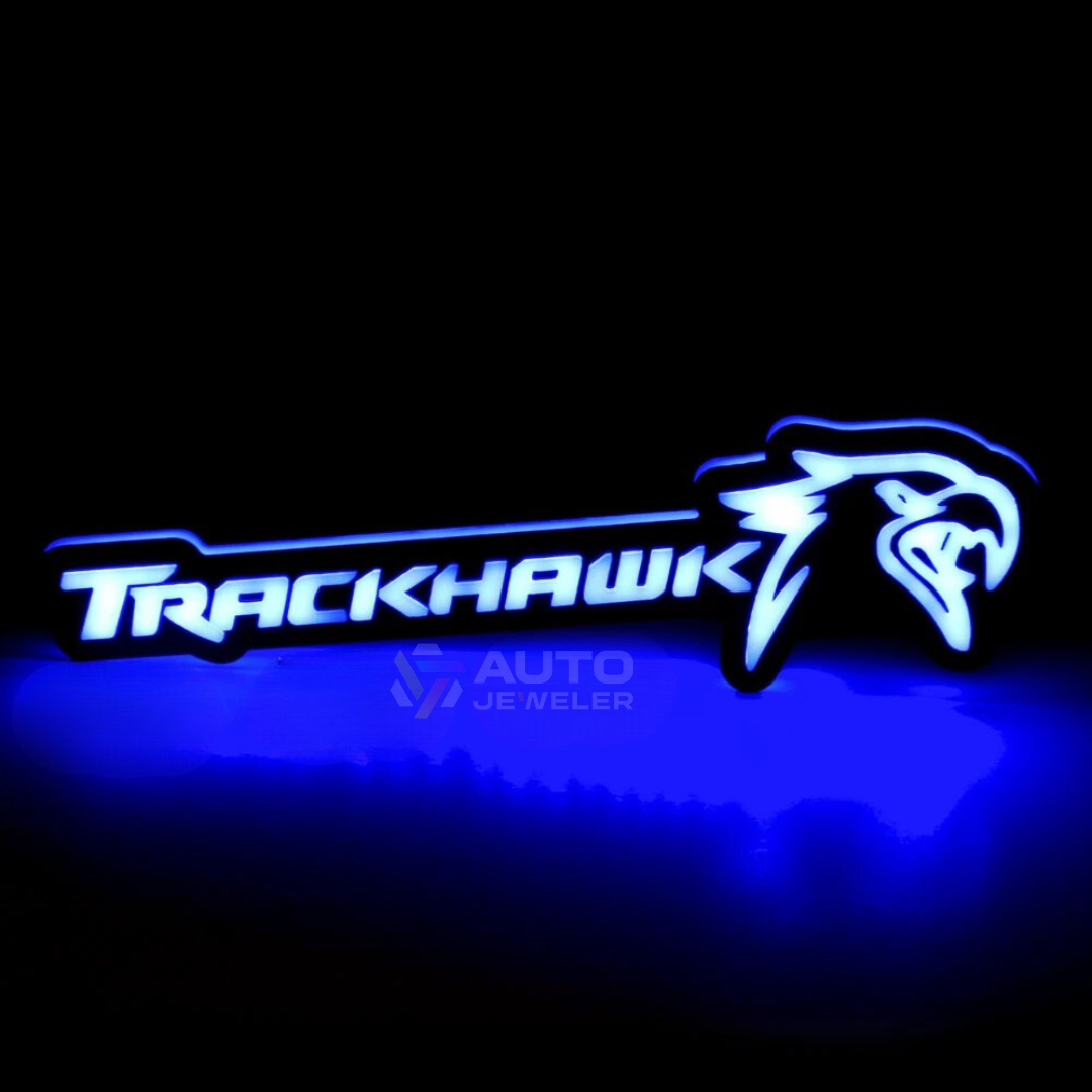 Jeep Trackhawk RGB Flow Series LED grille emblem glowing blue, Bluetooth app-controlled illuminated badge for 2018–2021 Grand Cherokee Trackhawk