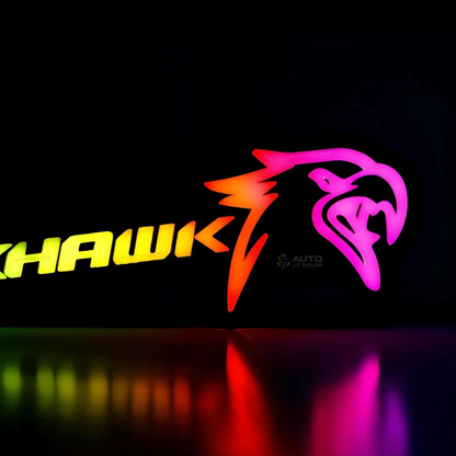 Close-up detail of Jeep Trackhawk RGB Flow Series LED grille emblem showing hawk logo and multicolor flow lighting