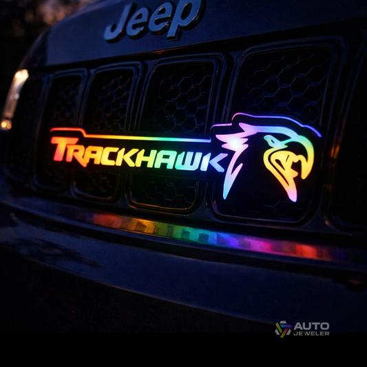 Jeep Trackhawk RGB Flow Series LED grille emblem installed at night with multicolor flow lighting on front grille