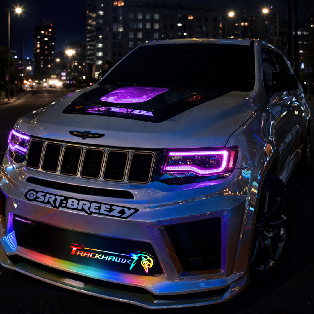 Jeep Trackhawk RGB Flow Series LED grille emblem installed at night in urban setting with multicolor flow lighting