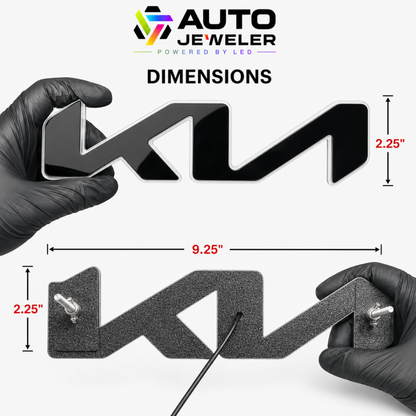 A dimension diagram for an LED Kia "KN" style grille emblem showing the logo's front side with a gloss mirror like finish and the back with pre-installed mounting studs and wand wing nuts. The emblem dimensions measure 9.25" wide x 2.25" tall.