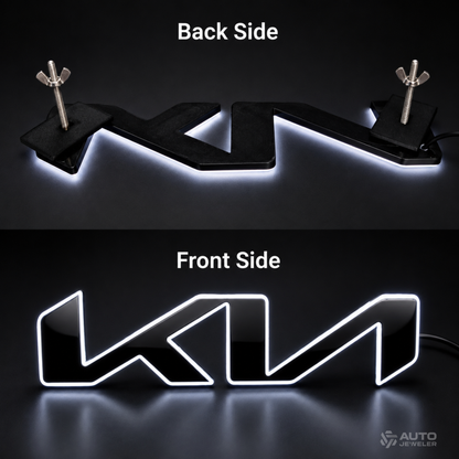 A black LED license plate light shown from both front and back sides on a dark background. The top panel shows the back side with mounting wings and a glowing white light strip underneath.