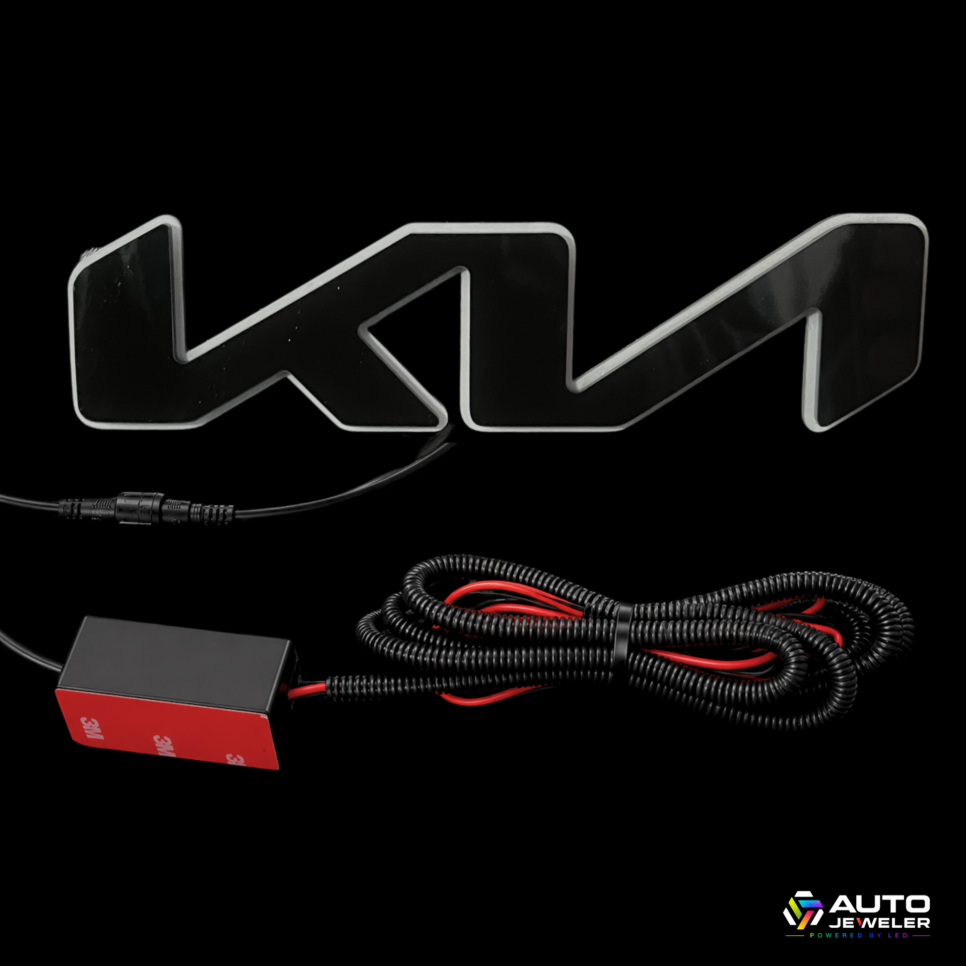 A black and silver metallic Kia logo light kit with a wiring harness, red power box, and connector, displayed on a solid black background.
