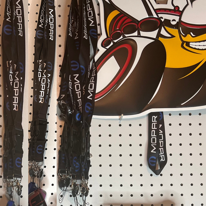 Multiple Mopar logo lanyards displayed on pegboard retail display