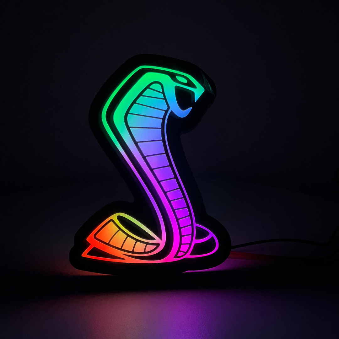 Mustang Cobra RGBW emblem in full-spectrum glow mode – dark room night view
