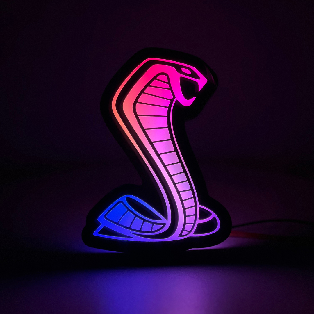 Mustang Cobra RGBW emblem in full-spectrum flow glow mode – dark room night view