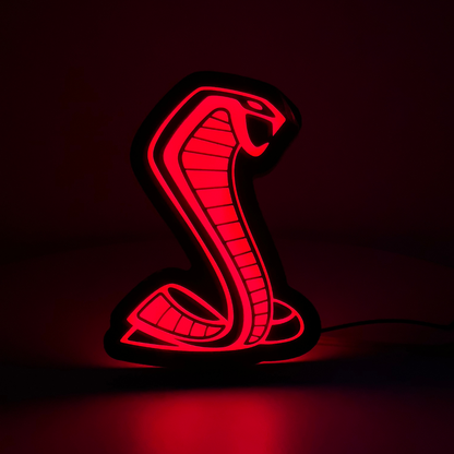 Mustang Cobra RGBW grille emblem glowing solid red in a dark environment, showcasing LED brightness and vivid illumination

