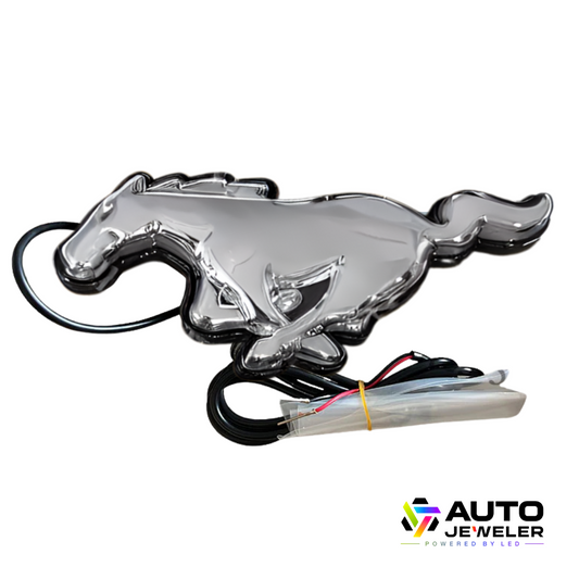 Angled view of 2015–2023 Ford Mustang S550 Chrome White LED pony grille emblem with glossy finish and wiring