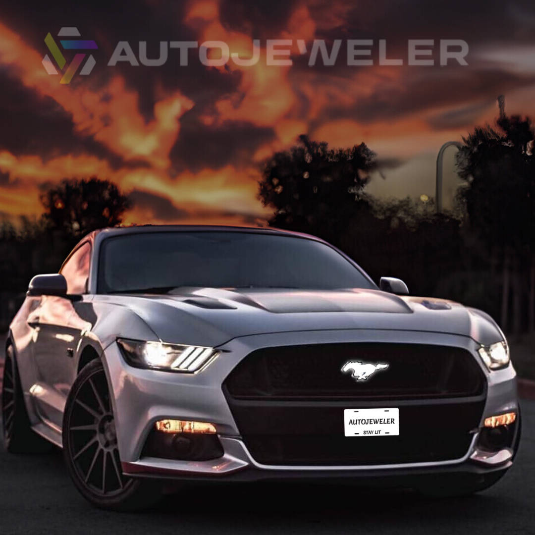 2015–2023 Ford Mustang S550 with White LED pony grille emblem illuminated during sunset drive, front view