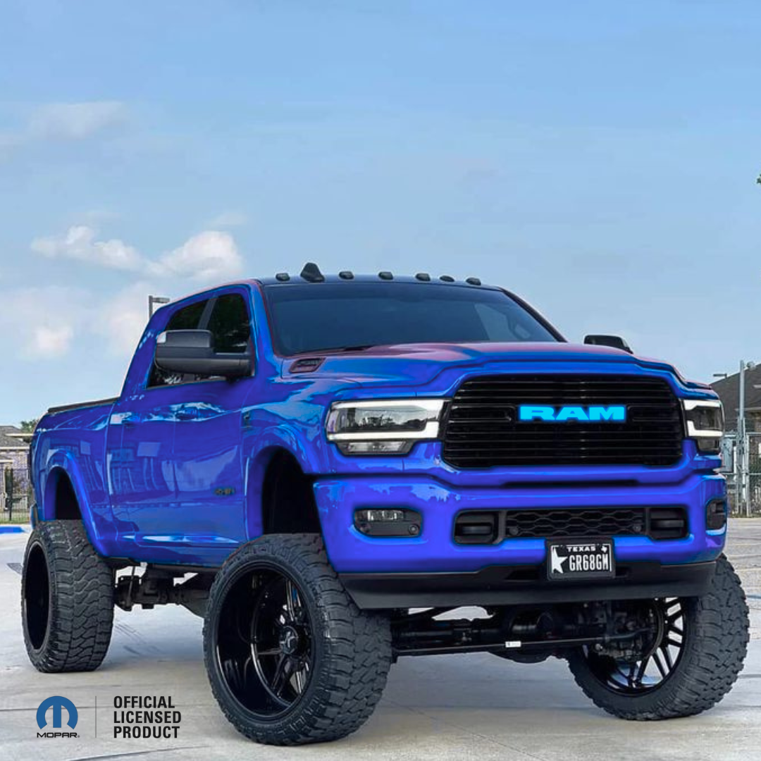 2019–2023 RAM 1500 with black RGB LED grille emblem, illuminated blue RAM letters, Mopar Official Licensed Product, color-changing LED truck emblem installed on lifted blue RAM 1500